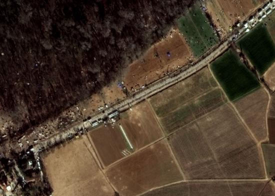 Satellite image at 30 cm resolution showing lines of refugees, tents along the road as well as extending into the forest and nearby crowding.  ðŸ“· 03/03/2020 by WorldView-3 © European Space Imaging 